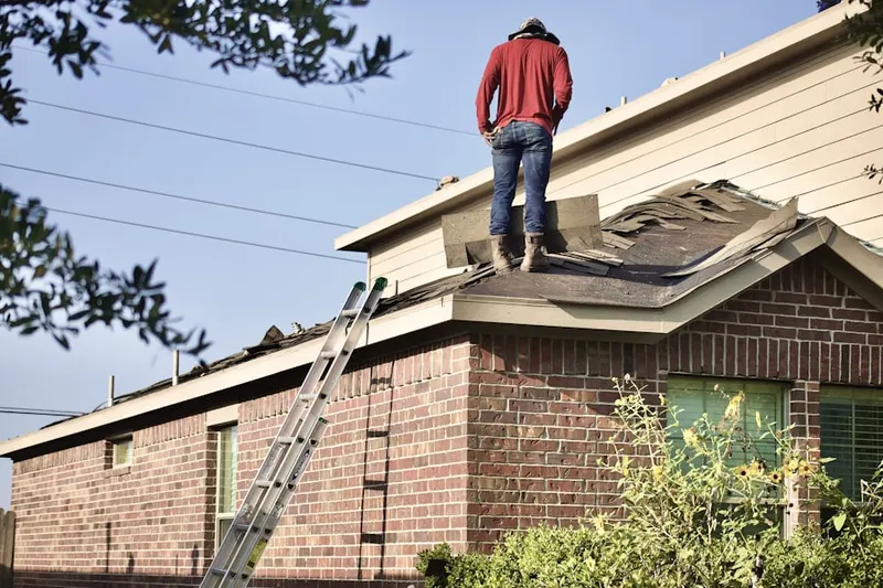 Professional roofer working on a residential roof in Prospect at Spring Meadows